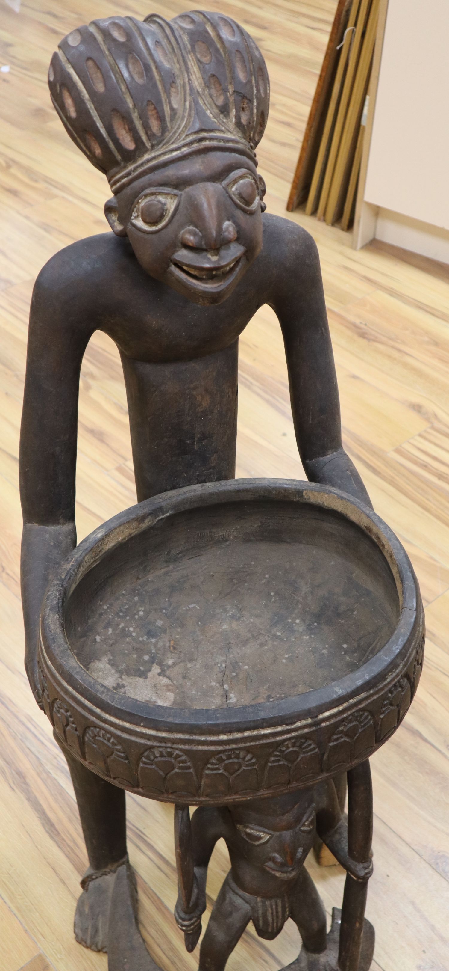 A large Bamileke carved wood figural storage vessel, Cameroon, length 109cm